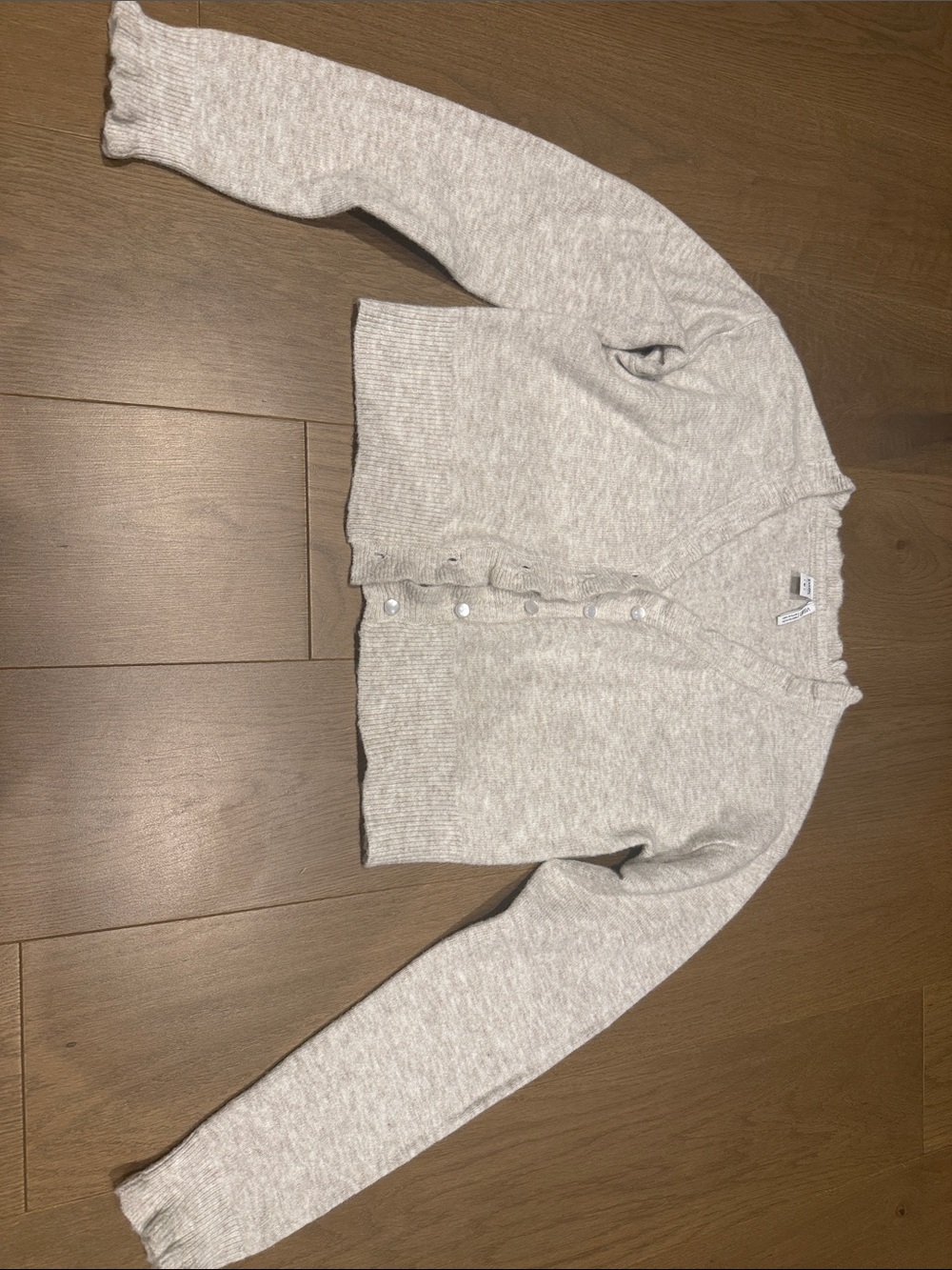 Cardigan with ruffle trim and pearl buttons